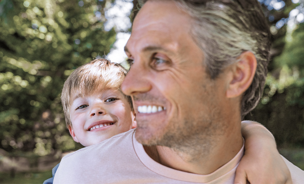 A father and son smiling