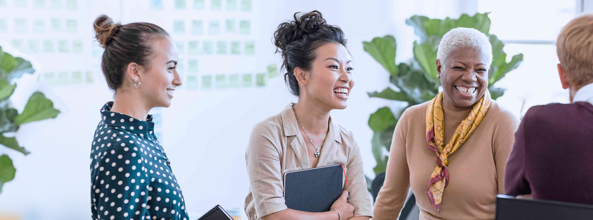 A group of smiling women talking and engaged with each other